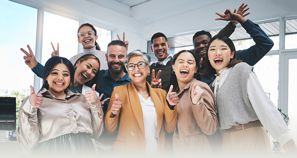 Several caregivers and assisted living residents smiling for a team portrait