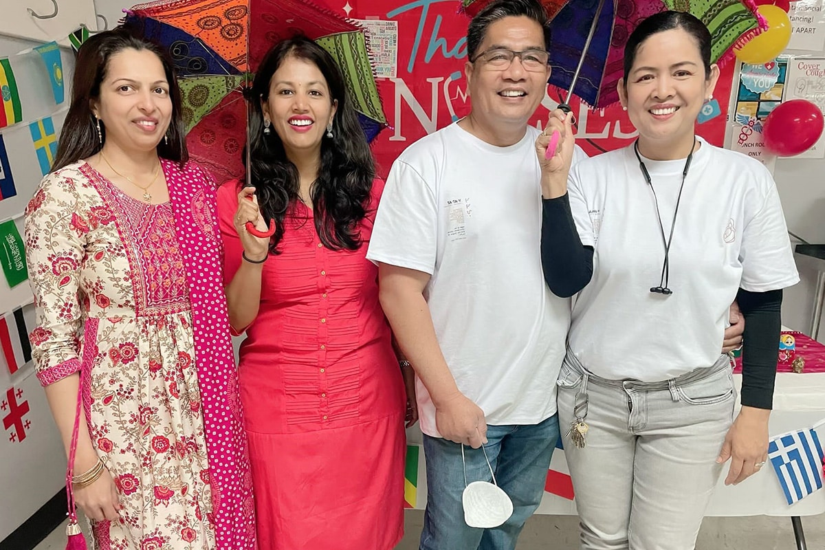 Four employees standing together at All Saints