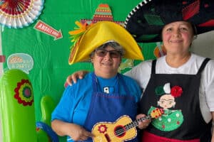 Two employees at an event at All Saints