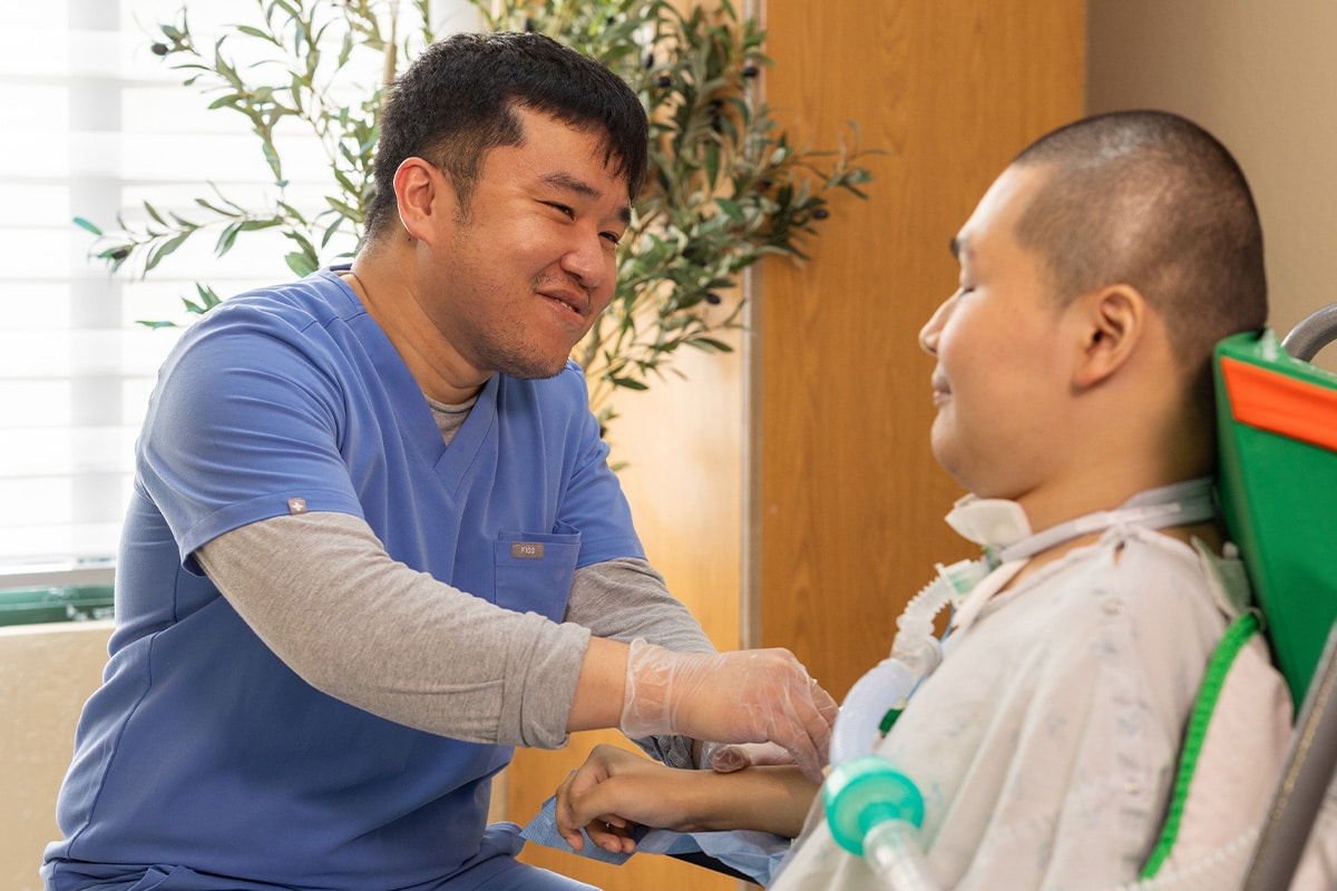 All Saints Post Healthcare nurse assisting resident with tracheostomy