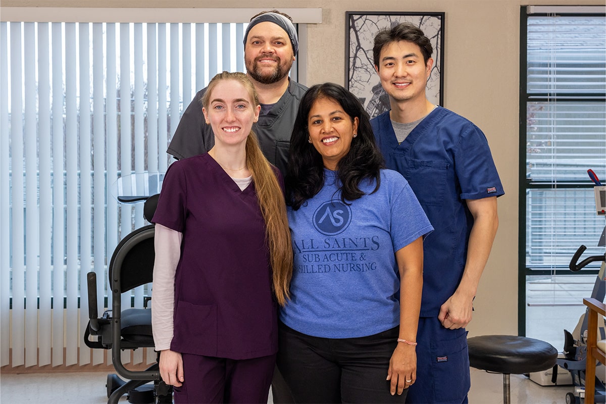 All Saints Post Healthcare staff group photo of nurses in blue scrubs